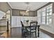 Dining room featuring neutral paint, wainscoting, hardwood floors, and a modern chandelier at 2975 Hickory Hill Rd, Brooks, GA 30205