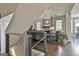 Comfortable living room featuring a stone fireplace, hardwood floors, and cable railing at 2975 Hickory Hill Rd, Brooks, GA 30205