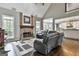 Bright living room with vaulted ceiling, stone fireplace, hardwood floors, and stylish seating at 2975 Hickory Hill Rd, Brooks, GA 30205