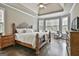 Beautiful main bedroom features a tray ceiling, windows, and hardwood floors at 2975 Hickory Hill Rd, Brooks, GA 30205