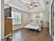 Main bedroom featuring tray ceiling, window, and hardwood floors at 2975 Hickory Hill Rd, Brooks, GA 30205
