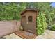 Charming wooden outbuilding with a small porch, surrounded by lush greenery at 2975 Hickory Hill Rd, Brooks, GA 30205