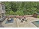 Rear patio perfect for entertaining with an outdoor kitchen and lounge area at 2975 Hickory Hill Rd, Brooks, GA 30205