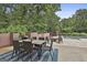 Relaxing patio with outdoor dining set, grill, and peaceful garden and pool view at 2975 Hickory Hill Rd, Brooks, GA 30205
