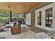 Relaxing screened porch featuring an outdoor kitchen, seating, and access to the backyard at 2975 Hickory Hill Rd, Brooks, GA 30205