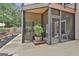 Comfortable screened porch with stone flooring and a serene view of the lush backyard at 2975 Hickory Hill Rd, Brooks, GA 30205