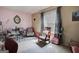 Comfortable bedroom featuring a rocking chair, pink walls and decorative mirror creating a cozy retreat at 7101 Brecken Pl, Lithonia, GA 30058