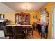 Classic dining room featuring a wooden table set and vintage hutch against sunny yellow walls at 7101 Brecken Pl, Lithonia, GA 30058