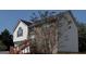 Charming home with a two car garage, brick and vinyl siding, and a stairway leading to the front door at 7101 Brecken Pl, Lithonia, GA 30058