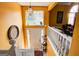 Inviting foyer featuring a staircase, large window, and bright yellow walls creating a warm and welcoming atmosphere at 7101 Brecken Pl, Lithonia, GA 30058