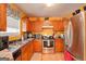 Efficient kitchen with stainless steel appliances, wood cabinets, and ample counter space, perfect for cooking and entertaining at 7101 Brecken Pl, Lithonia, GA 30058