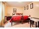 Cozy bedroom featuring a comfortable red bed, warm-toned walls and three art pictures, creating a relaxing retreat at 7101 Brecken Pl, Lithonia, GA 30058