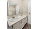 Bathroom features double sink vanity, large mirror, and a shower with a glass door at 368 Hemlock Ln, Locust Grove, GA 30248