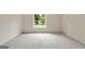 Bright bedroom with a window providing natural light and neutral carpet floors at 368 Hemlock Ln, Locust Grove, GA 30248