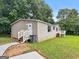 Exterior view of home featuring a green lawn and mature landscaping at 368 Hemlock Ln, Locust Grove, GA 30248