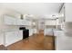 Bright kitchen featuring white cabinets, wood flooring, and modern appliances creating a functional space at 368 Hemlock Ln, Locust Grove, GA 30248