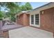 Back patio featuring a deck and double doors leading into the brick home at 602 Pine Knoll Court, Mcdonough, GA 30252