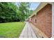 Well-maintained backyard featuring a brick house with a walkway at 602 Pine Knoll Court, Mcdonough, GA 30252