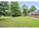 Expansive backyard with lush green grass and mature trees at 602 Pine Knoll Court, Mcdonough, GA 30252