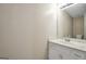 A bathroom with a white vanity and sink, and neutral-toned walls and countertop at 602 Pine Knoll Court, Mcdonough, GA 30252