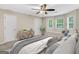 Staged bedroom boasts 3 windows with a window seat, plush carpet, and neutral paint at 602 Pine Knoll Court, Mcdonough, GA 30252
