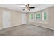 Spacious bedroom boasts 3 windows with a window seat, plush carpet, and neutral paint at 602 Pine Knoll Court, Mcdonough, GA 30252