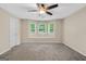 Spacious bedroom featuring a ceiling fan and bright bay windows offering natural light at 602 Pine Knoll Court, Mcdonough, GA 30252