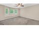 Spacious bedroom boasts 3 windows with a window seat, plush carpet, and neutral paint at 602 Pine Knoll Court, Mcdonough, GA 30252