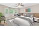 Staged bedroom boasts 3 windows with a window seat, plush carpet, and neutral paint at 602 Pine Knoll Court, Mcdonough, GA 30252