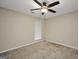 Neutral bedroom features a ceiling fan, neutral carpet, and a window allowing for natural light at 602 Pine Knoll Court, Mcdonough, GA 30252