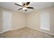 Neutral bedroom features a ceiling fan, neutral carpet, and a window allowing for natural light at 602 Pine Knoll Court, Mcdonough, GA 30252