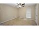 Neutral bedroom features a ceiling fan, neutral carpet, and a window allowing for natural light at 602 Pine Knoll Court, Mcdonough, GA 30252