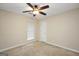 Neutral bedroom features a ceiling fan, neutral carpet, and a window allowing for natural light at 602 Pine Knoll Court, Mcdonough, GA 30252