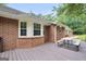 View of the outdoor deck of this home, complete with a brick exterior, large windows, and a picnic table at 602 Pine Knoll Court, Mcdonough, GA 30252