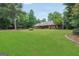 Spacious property with a well-maintained lawn, mature landscaping, and a charming brick facade at 602 Pine Knoll Court, Mcdonough, GA 30252
