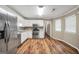 Bright kitchen with stainless appliances, tile backsplash, and wood-look floor at 602 Pine Knoll Court, Mcdonough, GA 30252