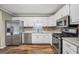 Modern kitchen with stainless steel appliances and updated backsplash at 602 Pine Knoll Court, Mcdonough, GA 30252