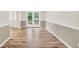 Bright living area with neutral paint and new wood-look flooring at 602 Pine Knoll Court, Mcdonough, GA 30252