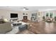 Stylishly staged living room with wood floors, fireplace, and seamlessly connects to the dining area at 602 Pine Knoll Court, Mcdonough, GA 30252