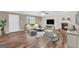 Staged living room with wood floors, fireplace, comfortable seating, and stylish decor at 602 Pine Knoll Court, Mcdonough, GA 30252