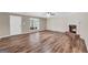 Inviting living room with wood floors, fireplace, and abundant natural light from a large window at 602 Pine Knoll Court, Mcdonough, GA 30252