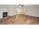 Spacious living room with a brick fireplace and wood-look flooring at 602 Pine Knoll Court, Mcdonough, GA 30252