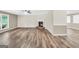 Bright living room with wood-look floors, a fireplace, and natural light at 602 Pine Knoll Court, Mcdonough, GA 30252