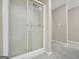 Bathroom shower enclosed with a semi-frosted glass door at 602 Pine Knoll Court, Mcdonough, GA 30252