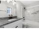 Updated bathroom with white cabinets, granite counters, and decorative tile surround at 1432 Almand Creek Drive Sw, Conyers, GA 30094