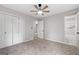 A ceiling fan and a door leading to the bathroom can be seen in the bedroom at 1432 Almand Creek Drive Sw, Conyers, GA 30094