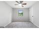 Bedroom with neutral walls, carpeting, ceiling fan, and a window with backyard view at 1432 Almand Creek Drive Sw, Conyers, GA 30094