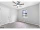 Bedroom featuring neutral walls, carpeting, ceiling fan, and window with backyard view at 1432 Almand Creek Drive Sw, Conyers, GA 30094