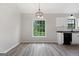 Dining area with wood-look floors, a window view, and an elegant light fixture at 1432 Almand Creek Drive Sw, Conyers, GA 30094