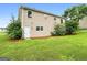 Home exterior featuring a spacious yard with lush green grass and mature trees at 1432 Almand Creek Drive Sw, Conyers, GA 30094